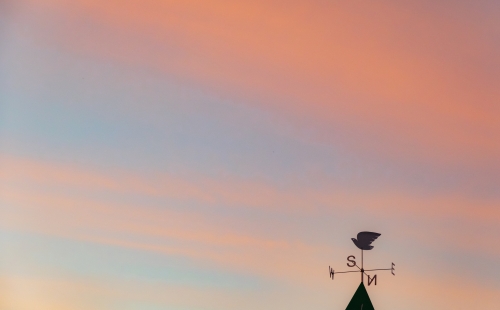 Weathervane against a sunset sky